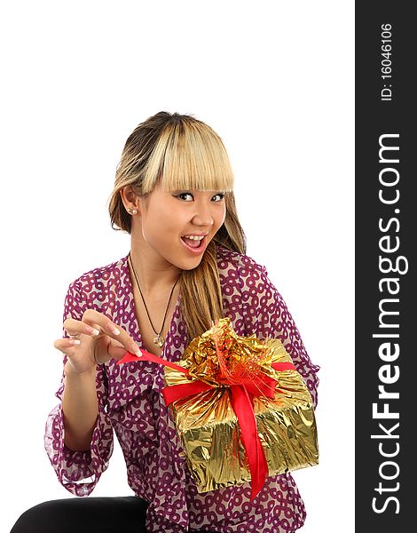 The young girl about a gift by a box it is isolated on a white background