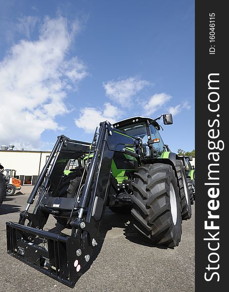 New tractors standing on line, trademarks removed. New tractors standing on line, trademarks removed
