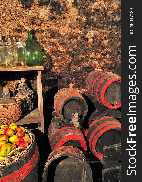 Old cellar with barrels and basket of apples