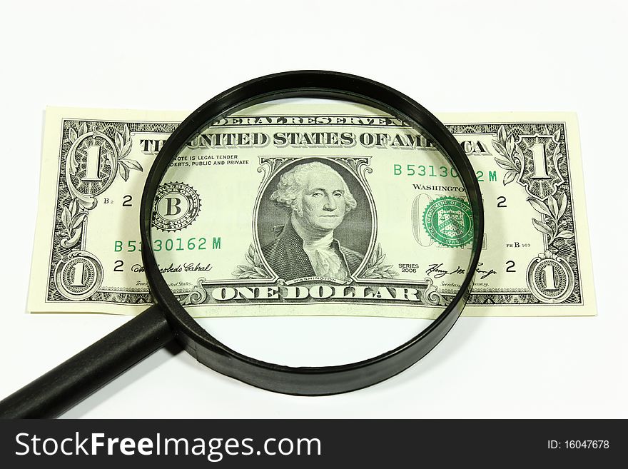 US dollar with a magnifier on a white background. US dollar with a magnifier on a white background