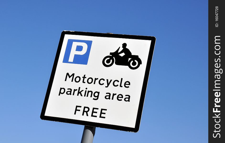 Motorcycle parking area sign against cloudless blue sky. Motorcycle parking area sign against cloudless blue sky