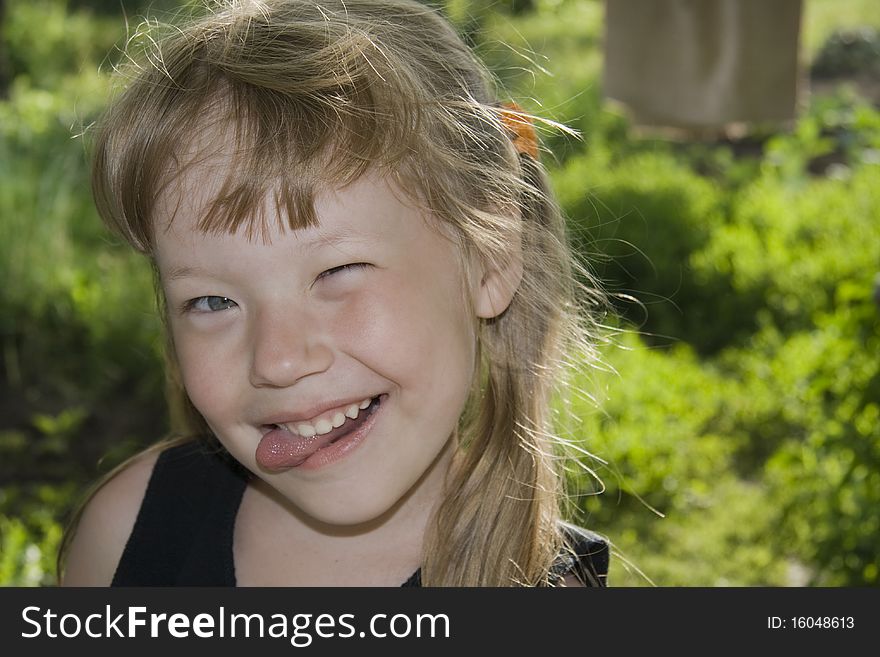 Little girl sticking out tongue.