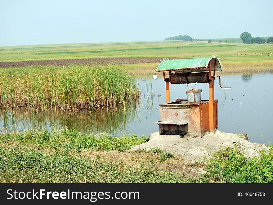 Old draw well by the lake