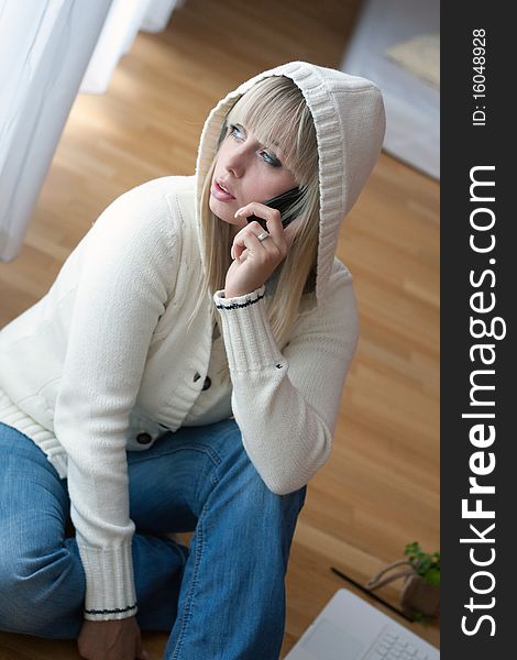 Young blond woman with a mobile phone