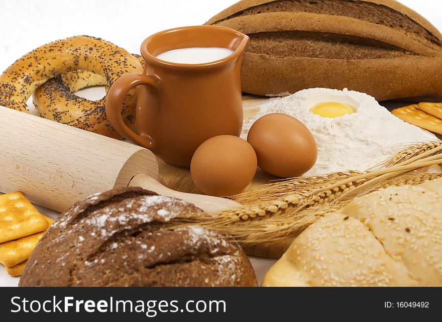 Nice fresh different bread, milk and eggs on white background. Nice fresh different bread, milk and eggs on white background
