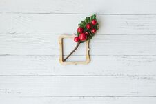 Christmas Background With Decorative Composition Of Wooden Frame And Branch With Red Berries On White Wooden Board. Happy New Year Stock Photos