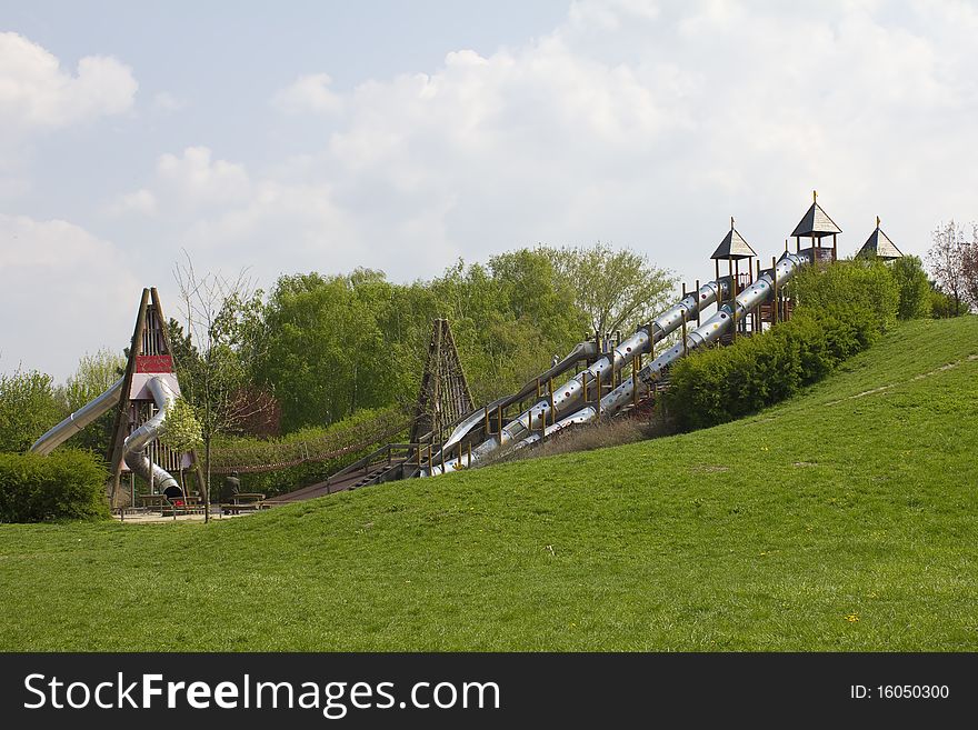 Large playground with slides and rope bridge