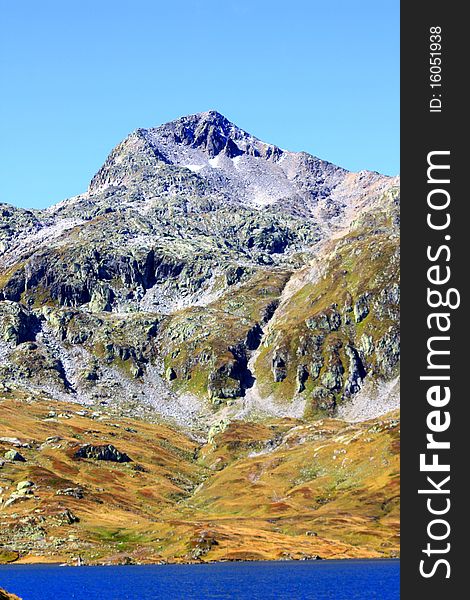 A snow capped Mountain overlooking a dam in Switzerland. A snow capped Mountain overlooking a dam in Switzerland