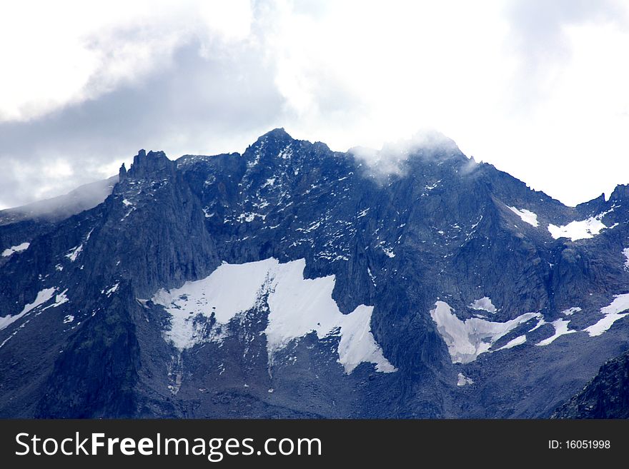 Snow Filled Mountains With Clouds