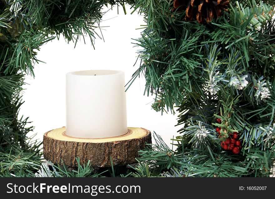 A closeup of an artifical wreath on a white background to celebrate the christmas spirit. A closeup of an artifical wreath on a white background to celebrate the christmas spirit.