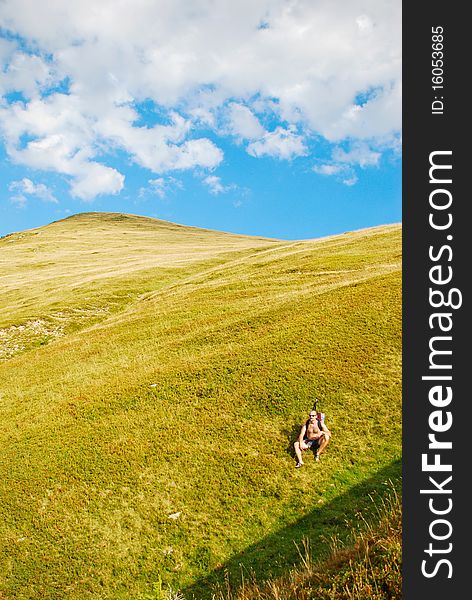 Hiker resting on mountain slope