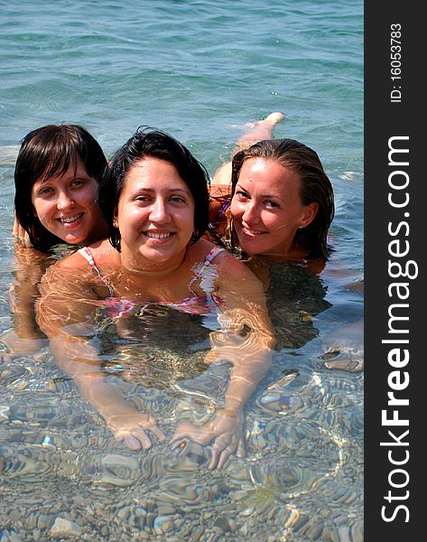 Three girls with smiling in the sea. Three girls with smiling in the sea