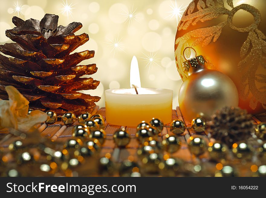 Christmas decoration with balls, fir cone and candlelight