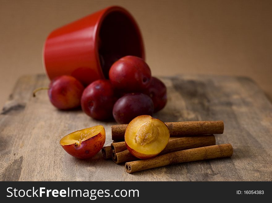 Pot of plums and cinnamon sticks