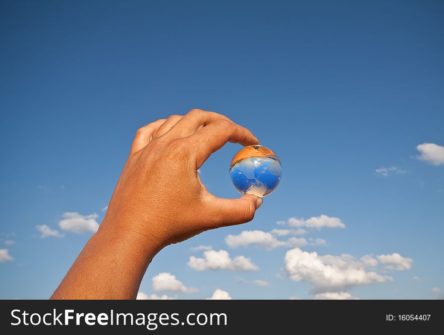 Fragile world - hand with glass globe