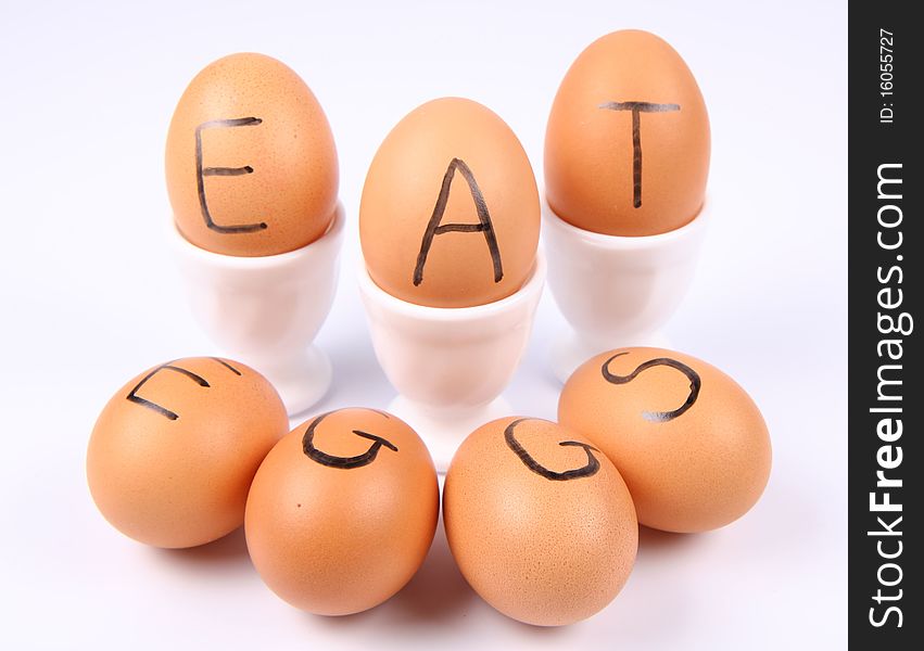 Eggs with an inscription EAT EGGS on white background