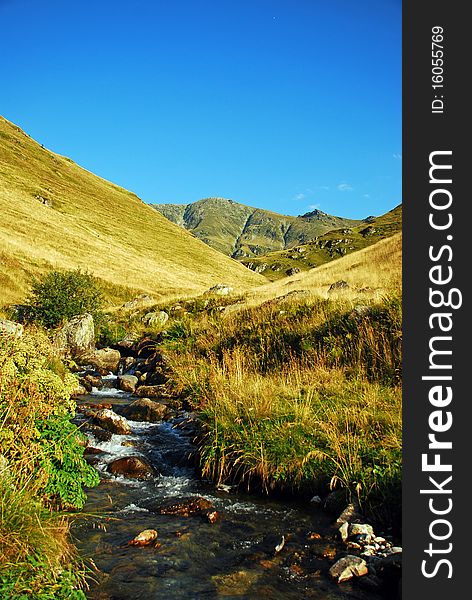 Mountain valley with water stream