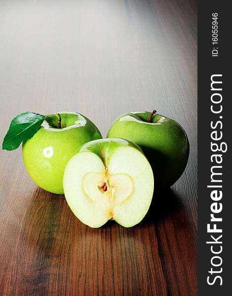 Shot of fresh green apples with green leaf on a table. Shot of fresh green apples with green leaf on a table.