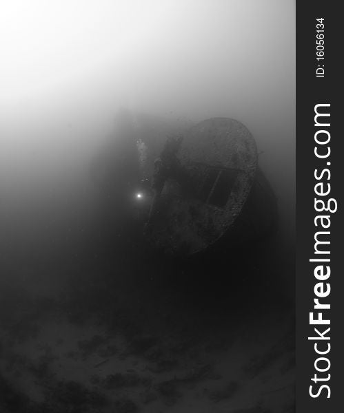 The stern section anti aircraft guns of the world war two shipwreck the SS Thistlegorm, Scuba diver in the background. Red Sea, Egypt. The stern section anti aircraft guns of the world war two shipwreck the SS Thistlegorm, Scuba diver in the background. Red Sea, Egypt.