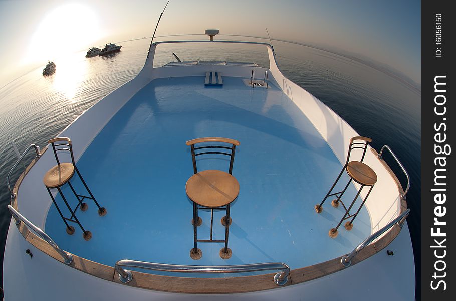 Sun deck of a boat used for sunbathing and relaxing with a a calm sea surrounding. Red Sea, Egypt. Sun deck of a boat used for sunbathing and relaxing with a a calm sea surrounding. Red Sea, Egypt.