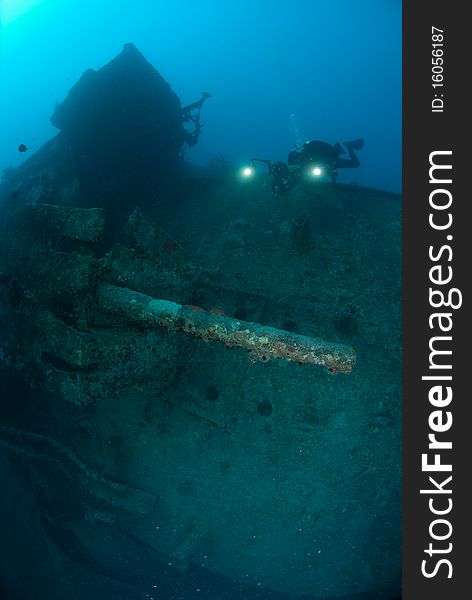 The stern section anti aircraft guns of the world war two shipwreck the SS Thistlegorm, Scuba diver in the background. Red Sea, Egypt. The stern section anti aircraft guns of the world war two shipwreck the SS Thistlegorm, Scuba diver in the background. Red Sea, Egypt.