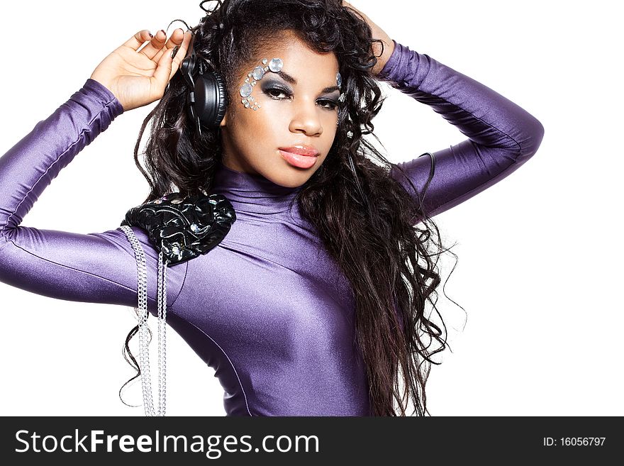 Mulatto girl DJ listens music with headphones