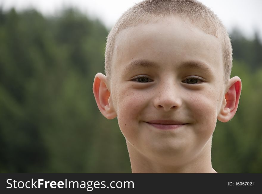 Smiling boy on a background the forest