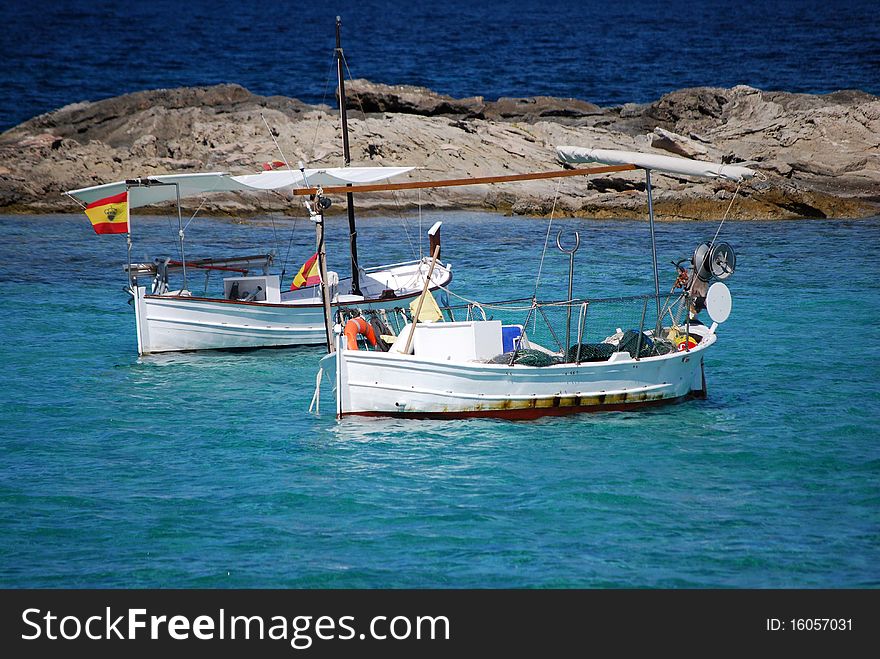 Two traditional fishing boats in the beach of Es Pujols, in the mediterranean island of Formentera.