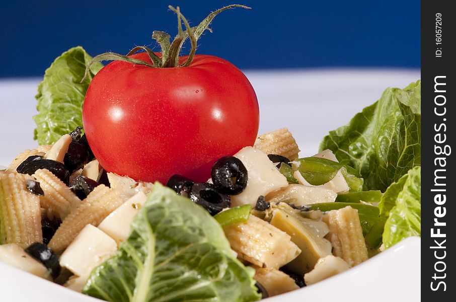 Antipasto salad with lettuce, tomatoes, olives and corn