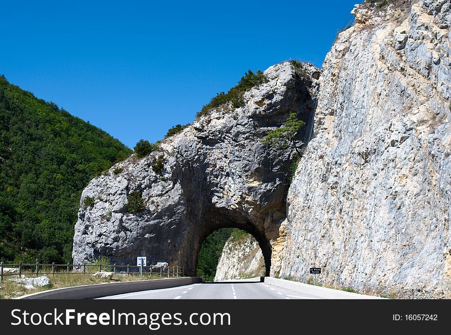 Rocky arc tunnel in mountain road, Province, France, EU