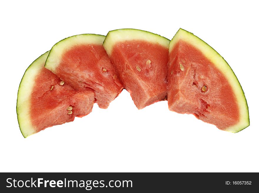 Four organic watermelon pieces side by side on white background. Four organic watermelon pieces side by side on white background.