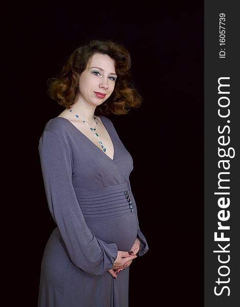 Portrait of pregnant woman on black background