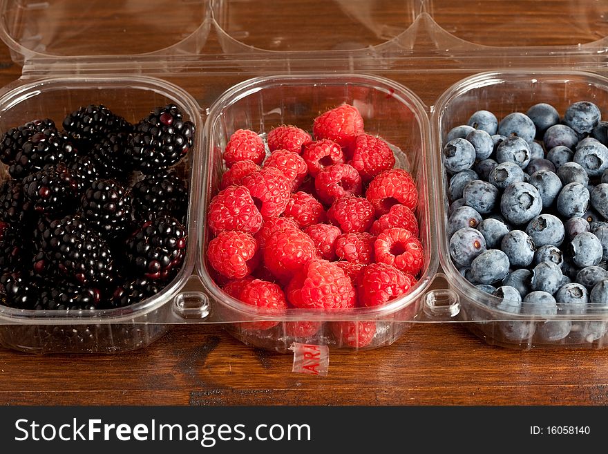 Macro photography of different blueberries and raspberries