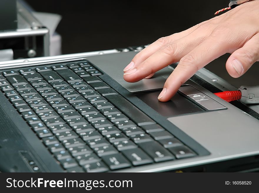 Close up of a hand typing on laptop keyboard. Close up of a hand typing on laptop keyboard