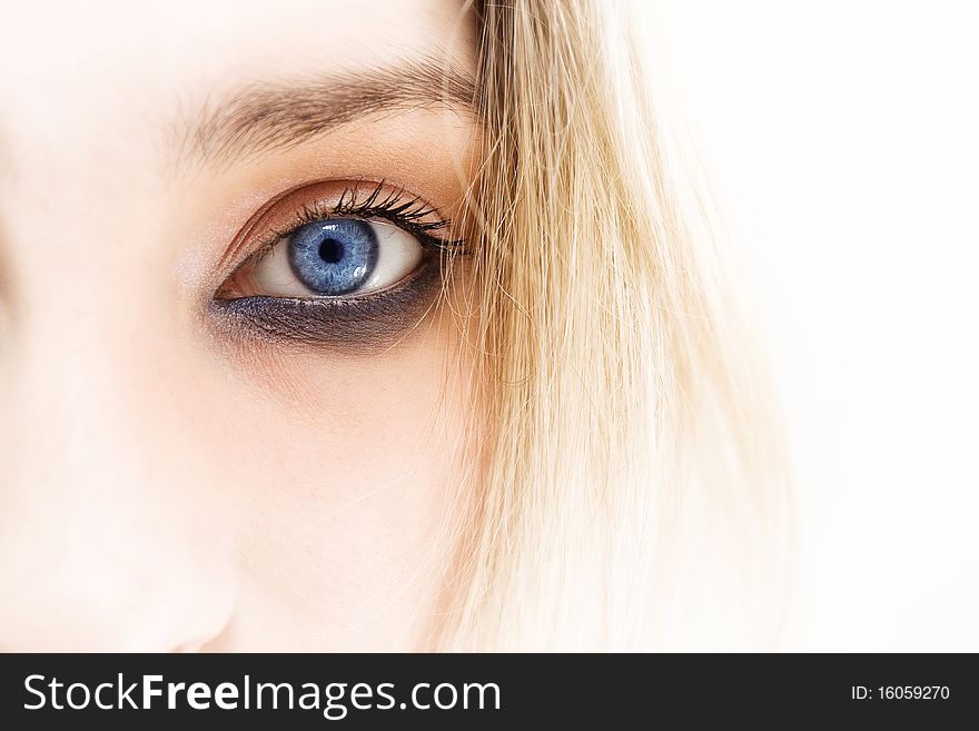 Woman eye, close-up shot, half face