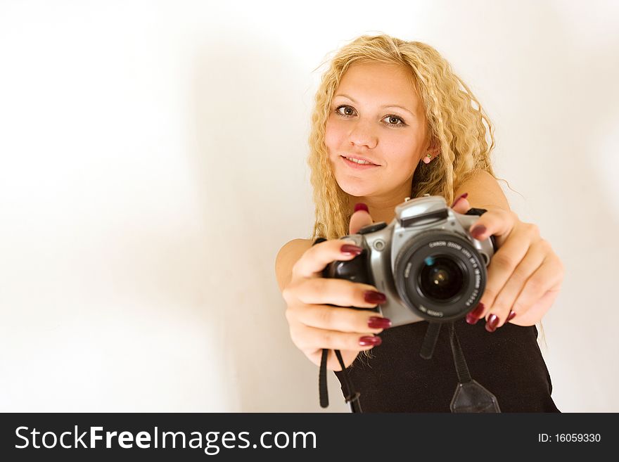 The young beautiful girl with the camera isolated on a white background