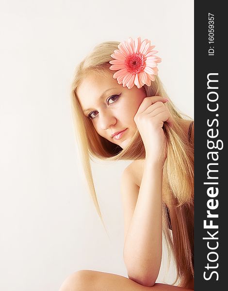 Beautiful young pretty woman with flower in hair