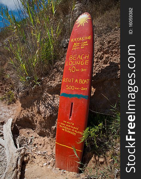 A surf board used as advertising for beach services. A surf board used as advertising for beach services.