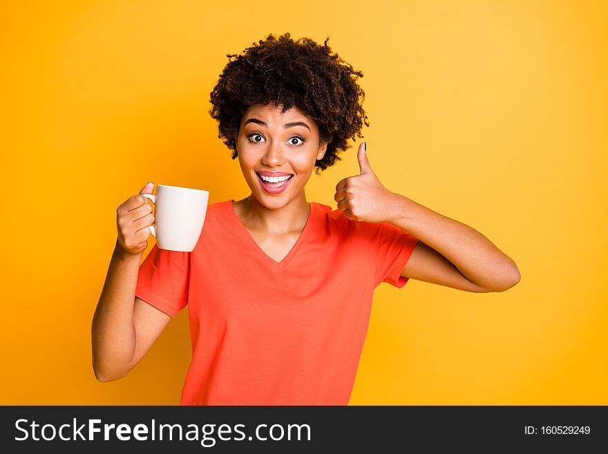 Photo of cheerful curly wavy trendy charming cute nice sweet black lady, recommending you to taste new sort of coffee thumbing up isolated over vivid color background. Photo of cheerful curly wavy trendy charming cute nice sweet black lady, recommending you to taste new sort of coffee thumbing up isolated over vivid color background