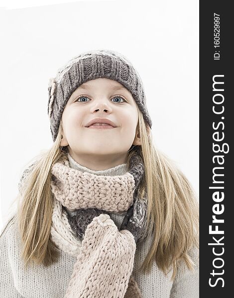 Adorable little girl in cap and scarf imagination. Winter style.