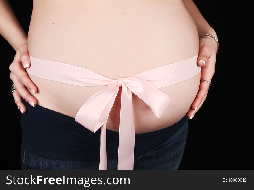 Pink Ribbon wrapped around pregnant womans stomach