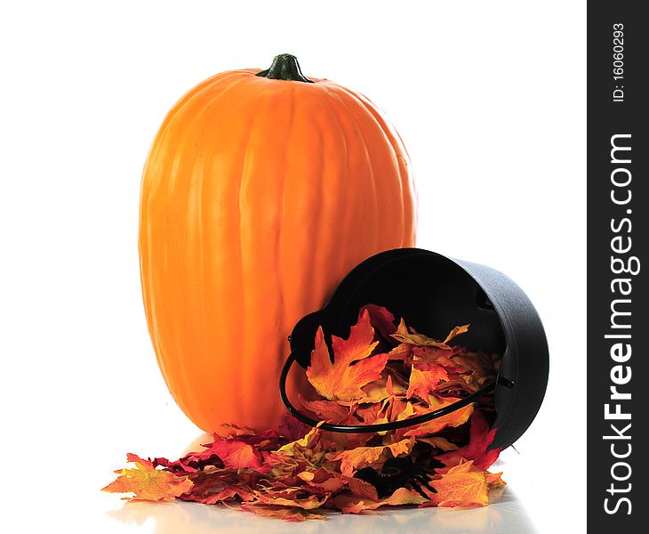 A simple still-life composed of a large pumpkin and colorful leaves spilling out of a small, tipped cauldron. Isolated on white. A simple still-life composed of a large pumpkin and colorful leaves spilling out of a small, tipped cauldron. Isolated on white.