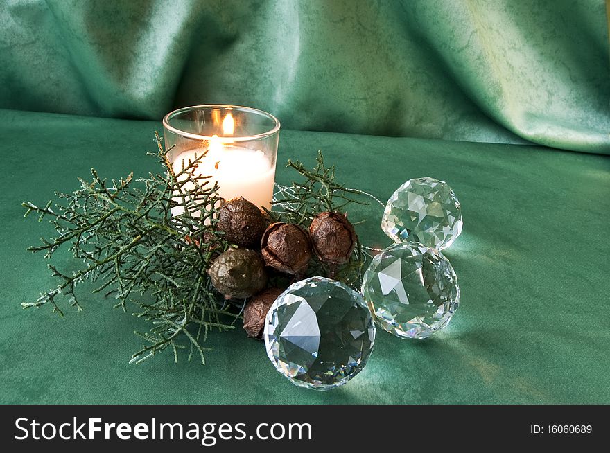 Crystal balls, pine branch and candle on black fabric. Crystal balls, pine branch and candle on black fabric