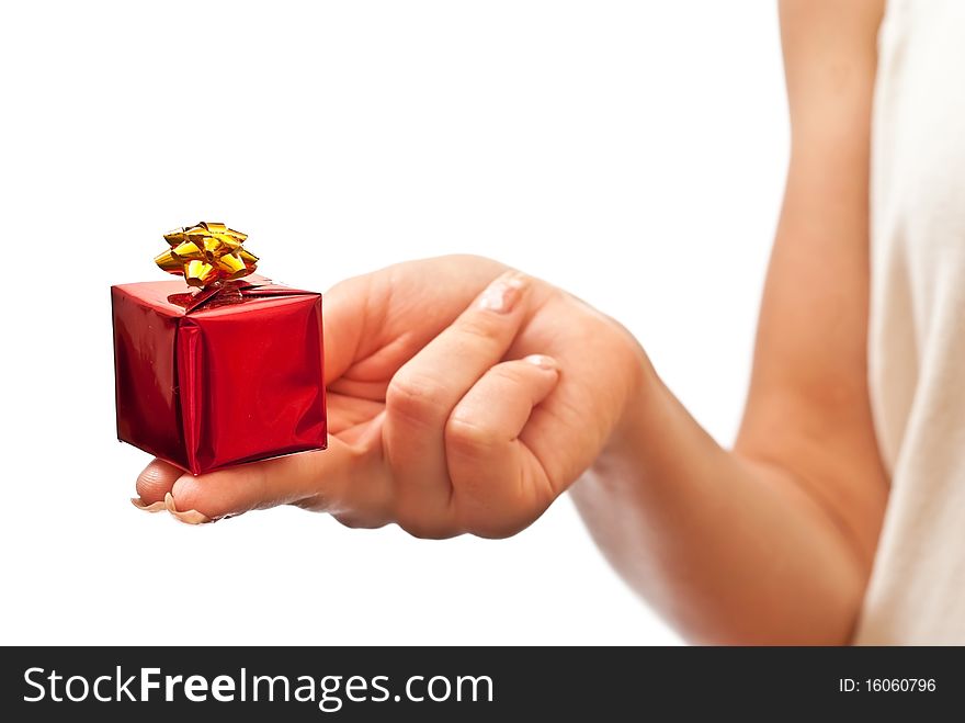 Hand with a small red gift box with gold bow isolated on white background. Hand with a small red gift box with gold bow isolated on white background
