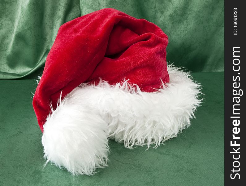 A Santa Claus hat on green background