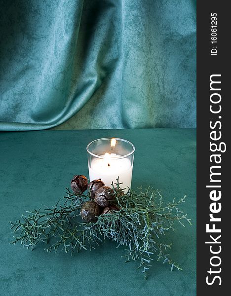 Crystal balls, pine branch and candle on green fabric. Crystal balls, pine branch and candle on green fabric