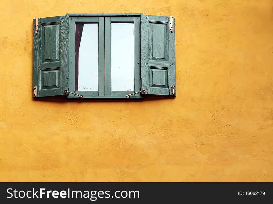 Green wooden windows on orange wall. Green wooden windows on orange wall