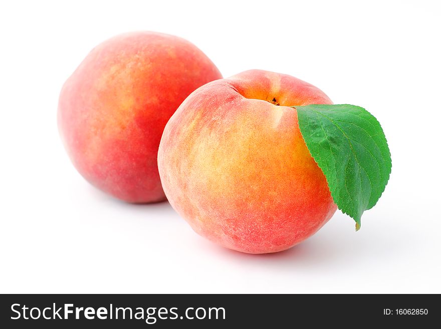 Two peaches isolated on white background
