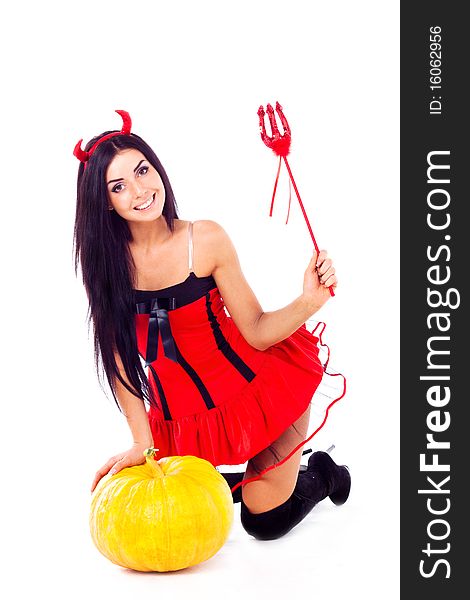 Girl dressed in Halloween costume imp, next
