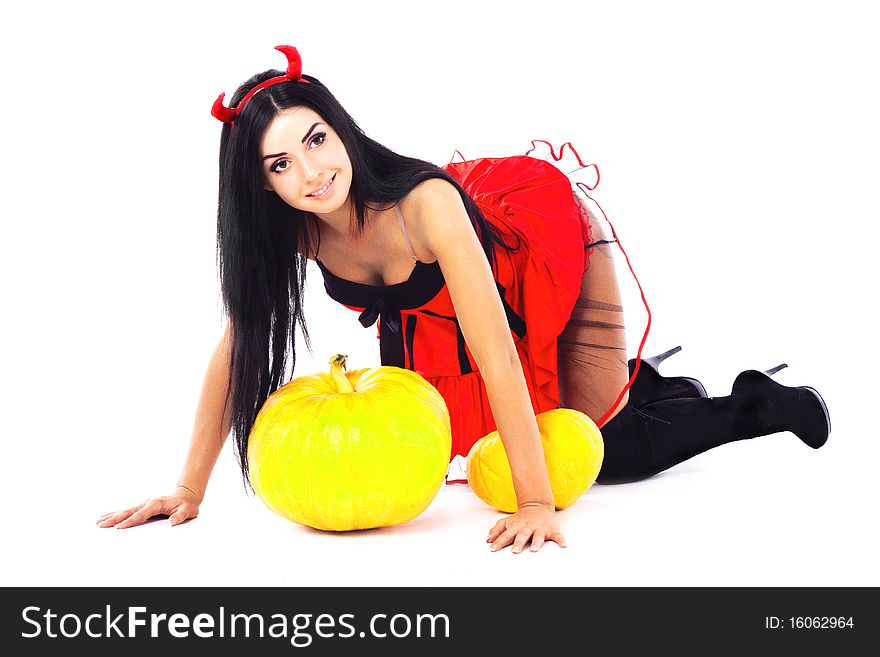 brunette girl sits, dressed in Halloween costume imp. brunette girl sits, dressed in Halloween costume imp